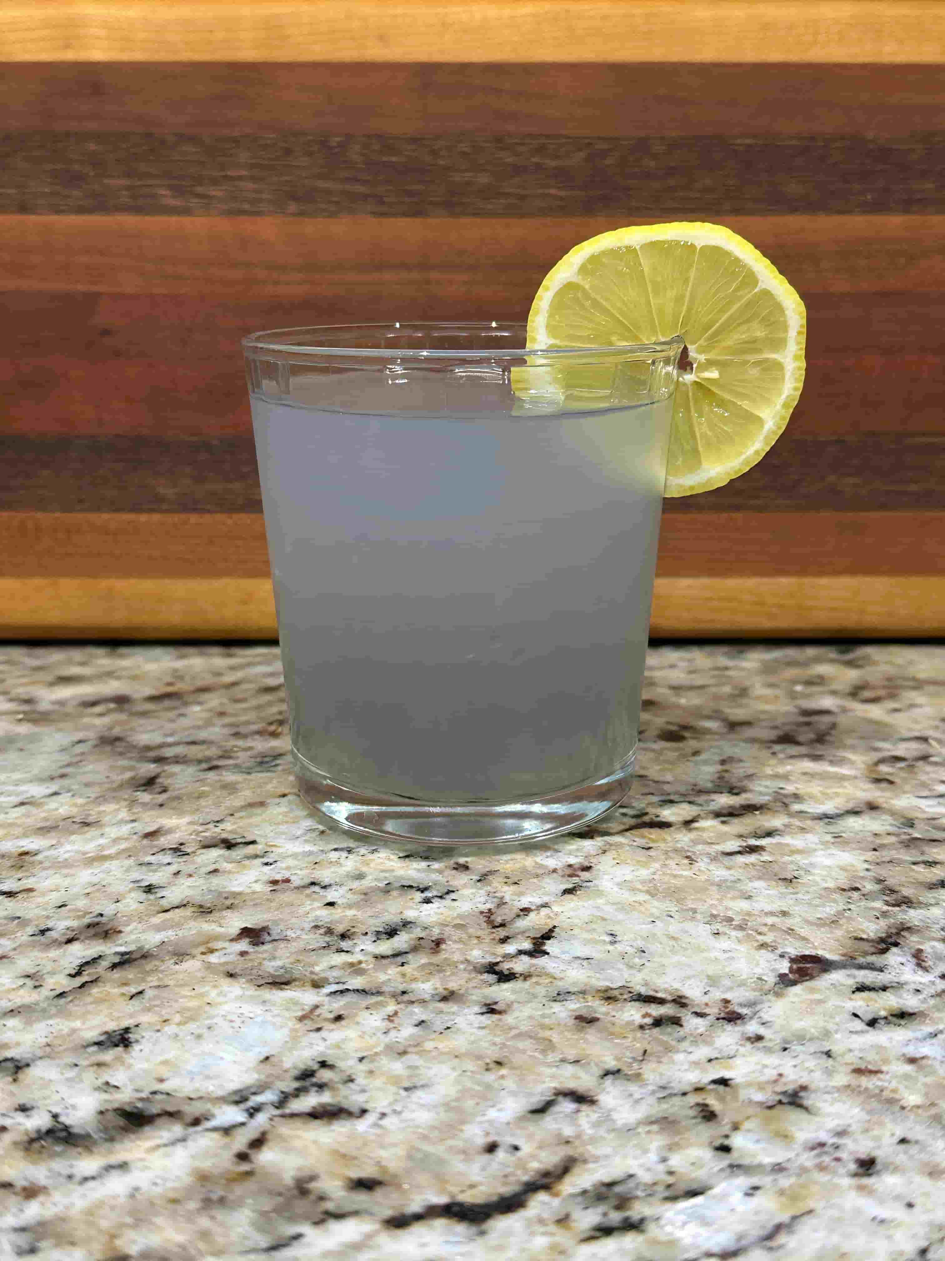Lavender Lemonade on a counter with a lemon slice