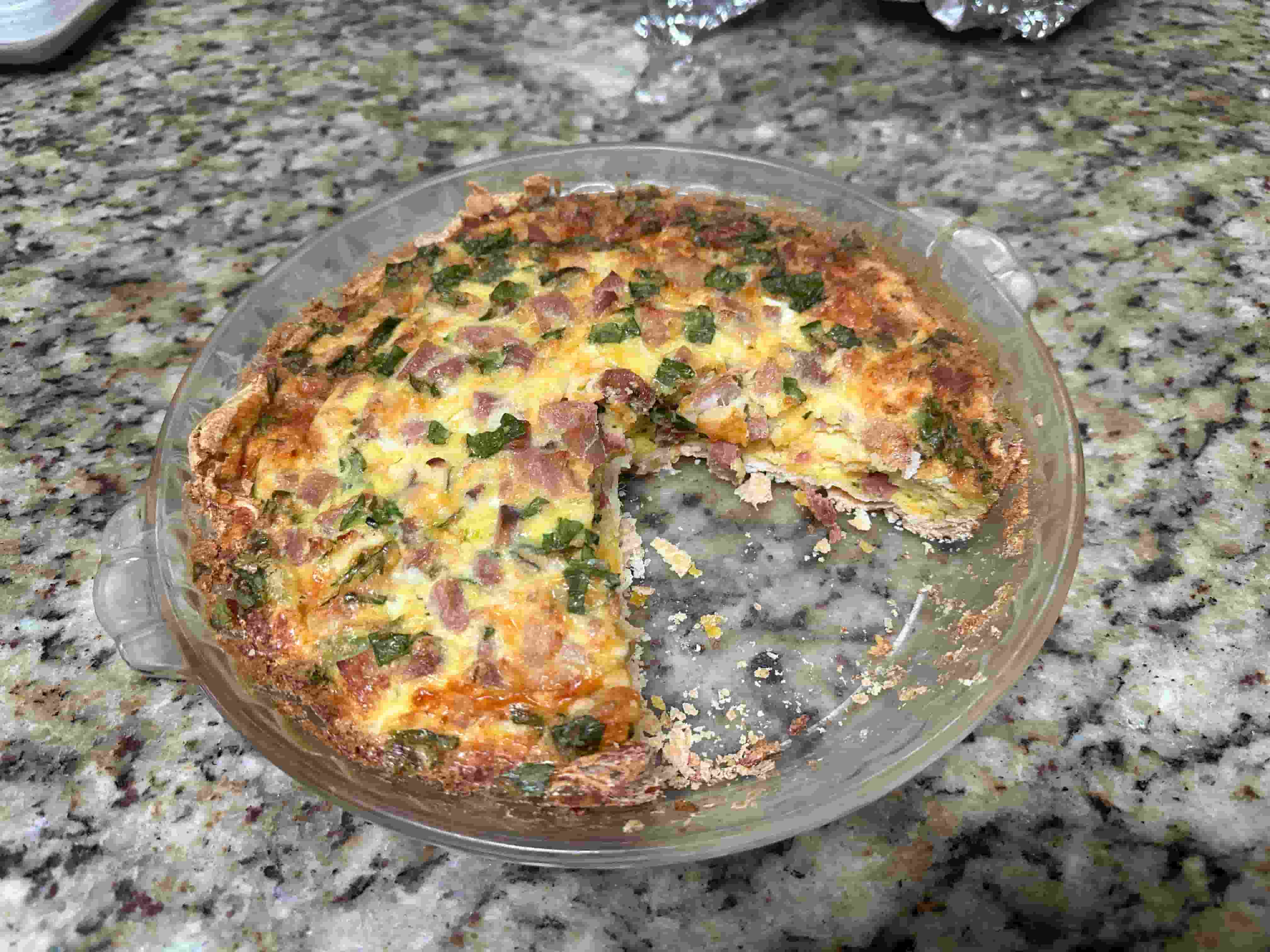 Ham and Guryere Quiche with a slice cut out of it